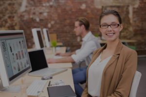 woman smiling at computer in office