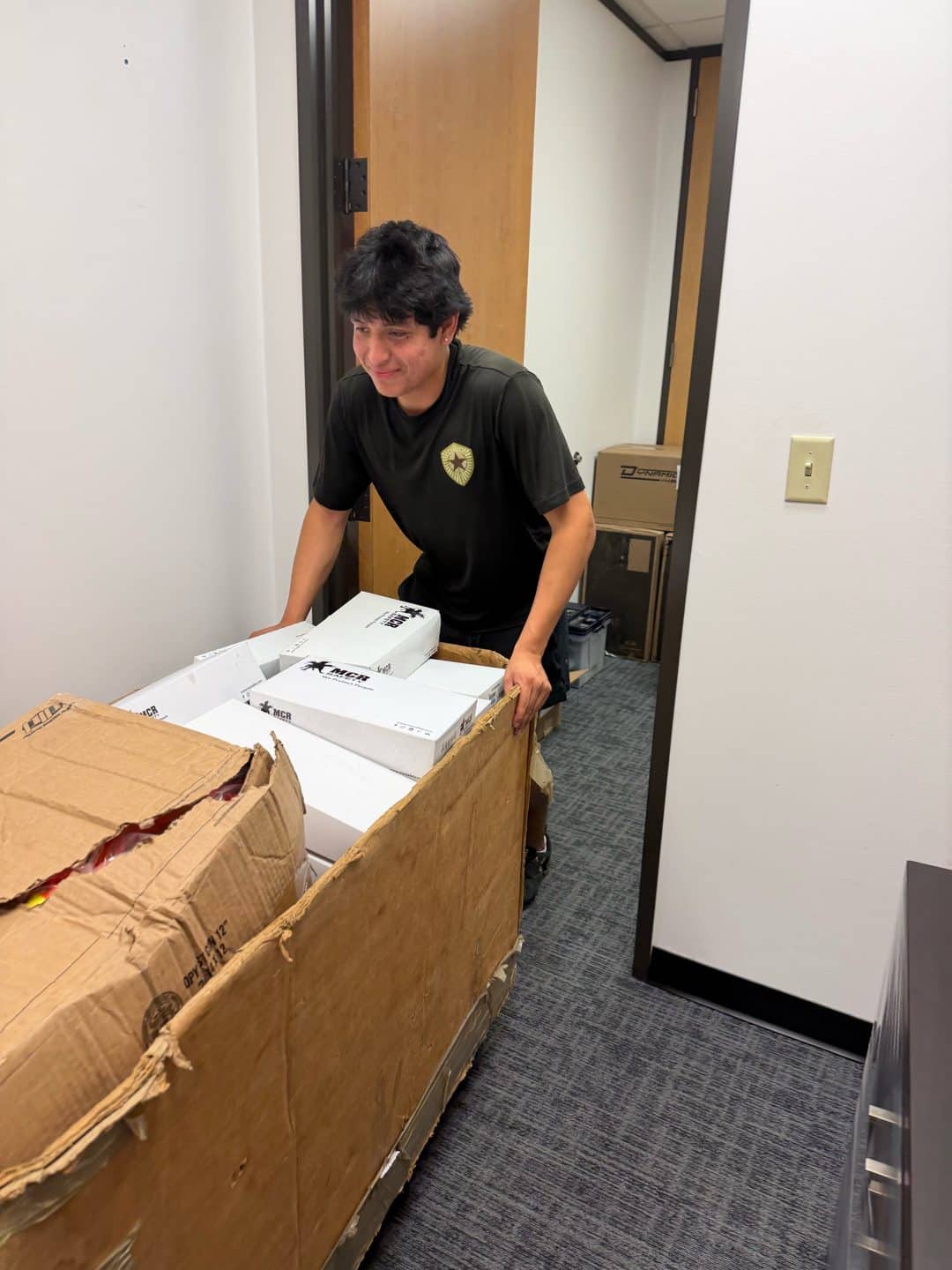 Elite Star Movers crew member pushing a cart of moving boxes