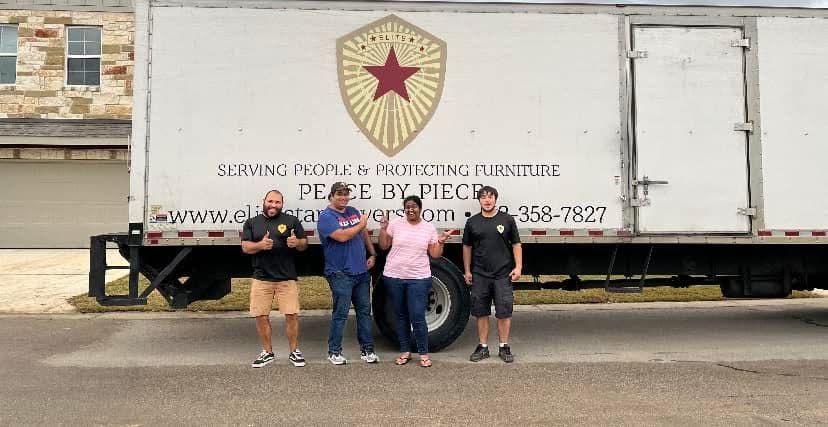 Elite Star Movers team smiling in front of the company box truck